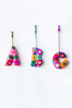 Colorful felt letters "A B C" with multicolor floral hand-embroidery hanging by colorful strings.