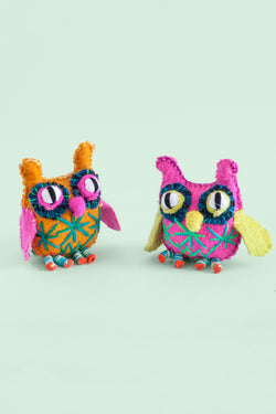 Two colorful felt owl plush toys with hand-embroidered features and star designs.