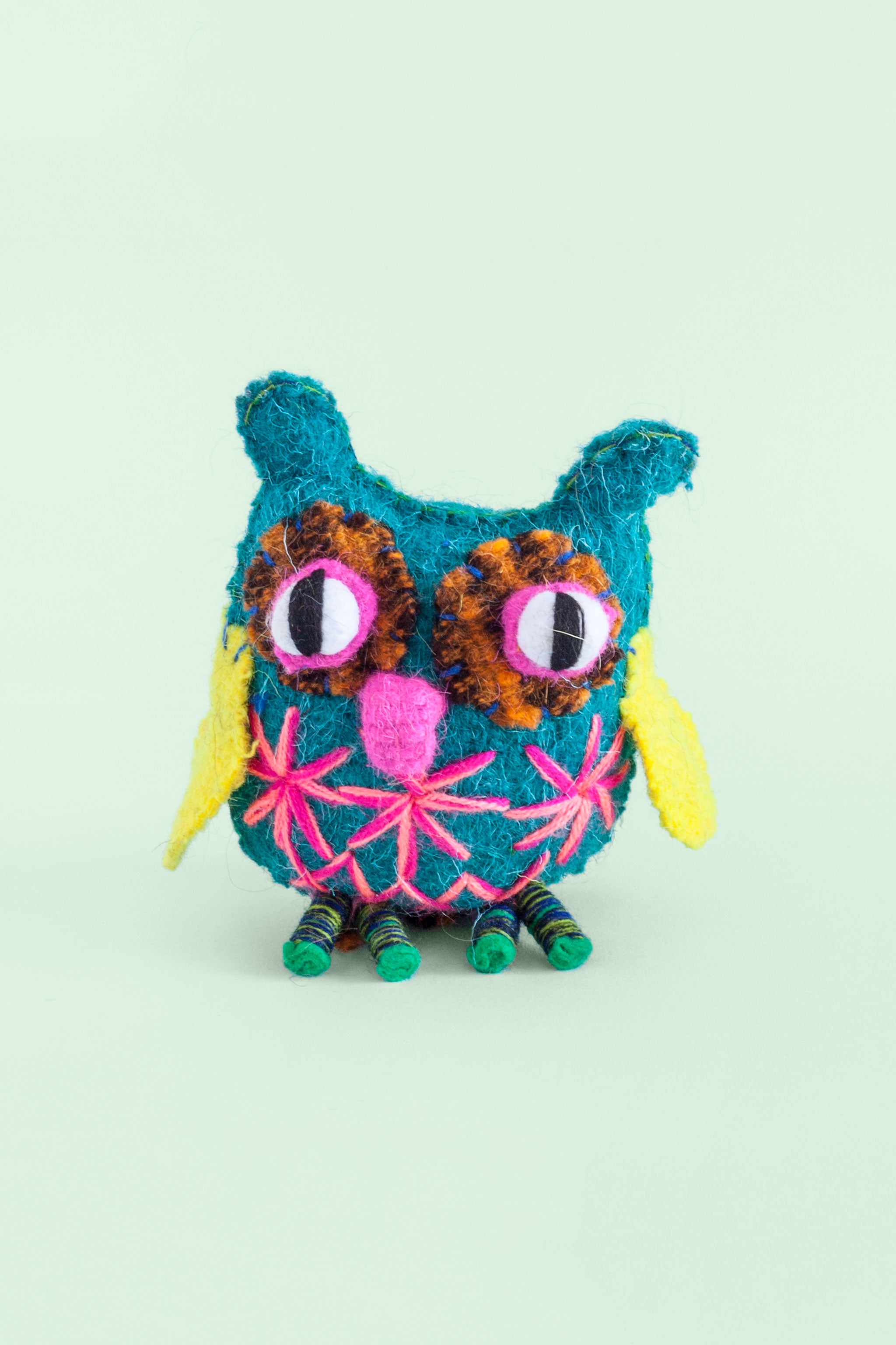 Colorful felt owl plush toy with hand-embroidered features and star designs.