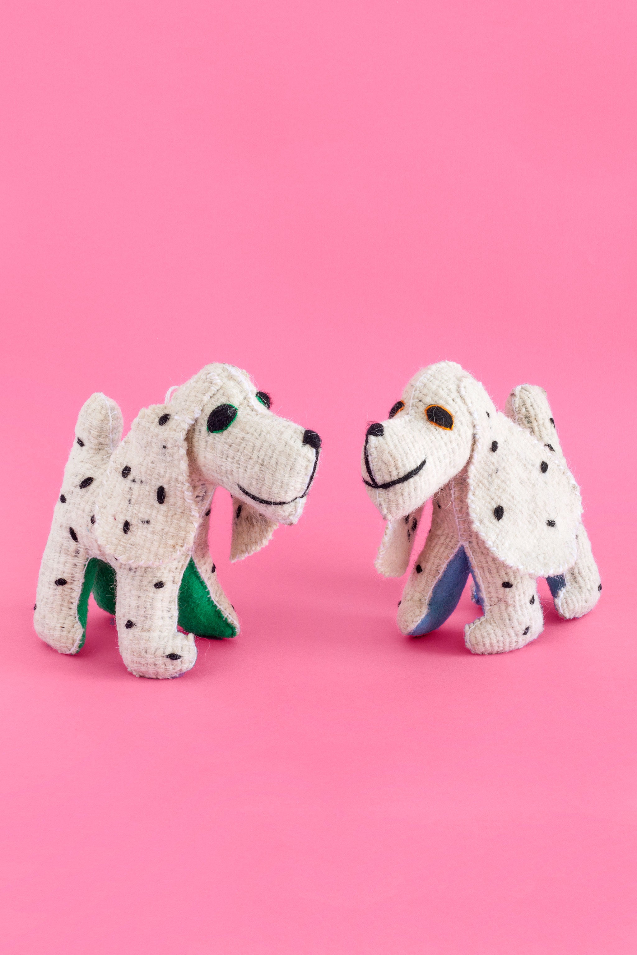 Two white felt Dalmatian plush toys with hand-embroidered black spots and features.