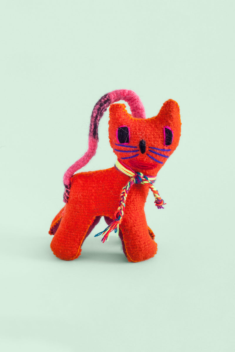 Colorful felt cat plush toy with colorful hand-embroidered features. Multicolor braided threads are tied around the cat's collar, and the tail is stitched from the rear to the head to use as a strap