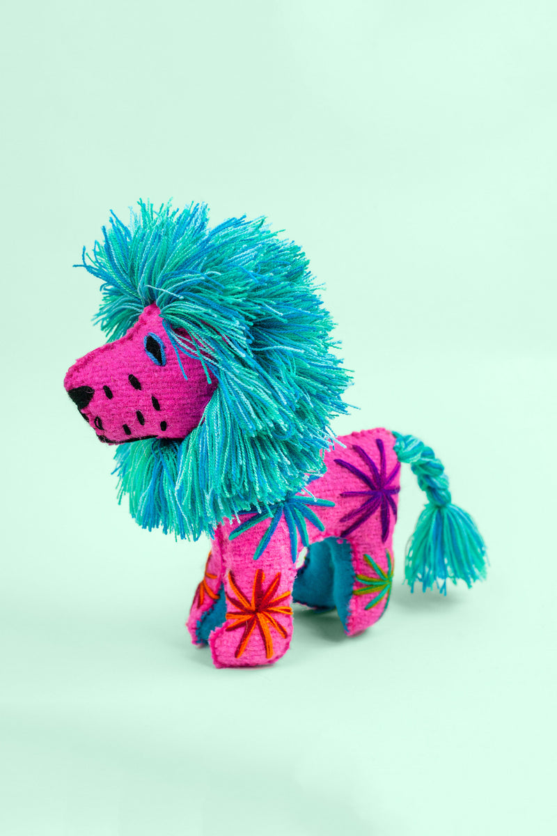 Colorful felt lion plush toy with multicolor braided tails and fringe manes. Hand-embroidered features and star designs across the body.