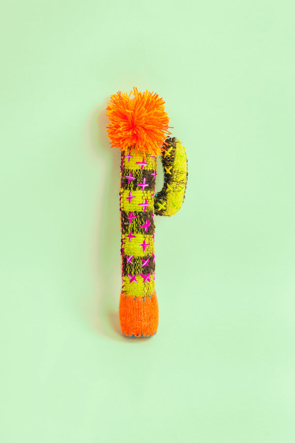 Standing green and black striped felt cactus plush toy with hand-embroidered thorns and a colorful pom pom flower on top.