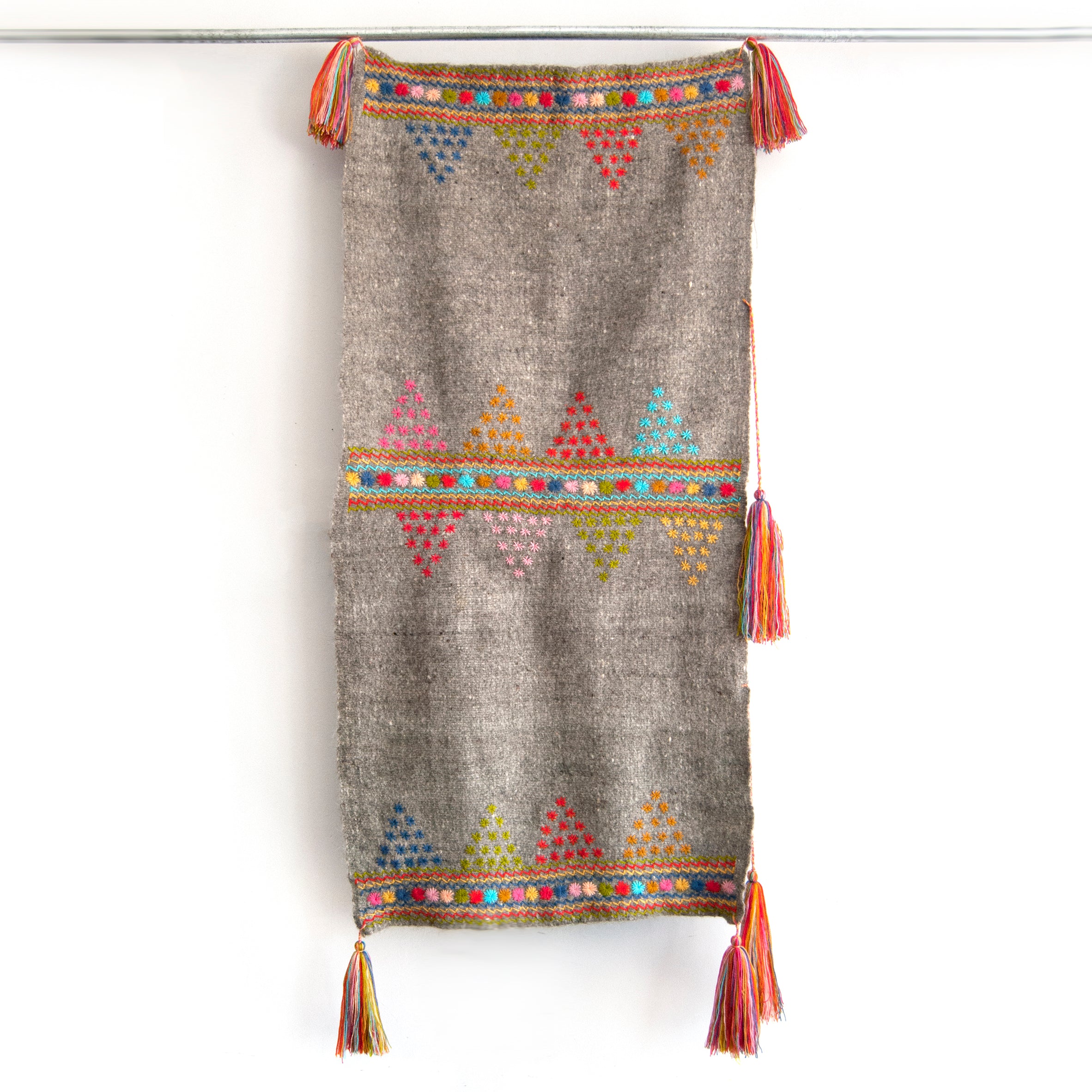 Rectangular grey wool throw with colorful embroidered trim & accents and multicolor tassels at each corner
